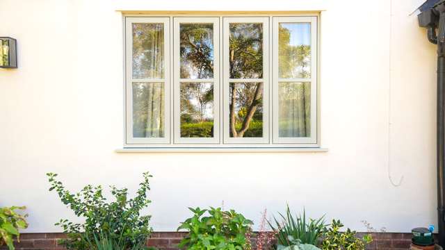 External close up of timber alternative flush UPVC windows.