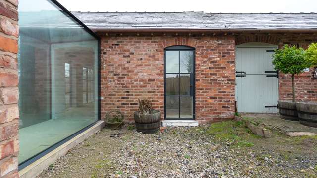 Alternative view of the glass corridor and single Crittall door.