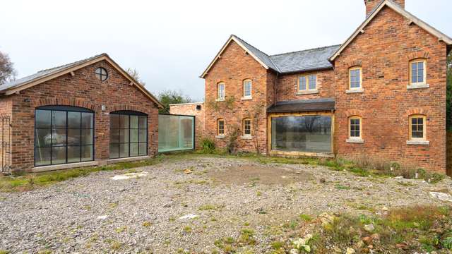 Main view of a large installation featuring Crittall windows, large OAK picture window and glass corridor.