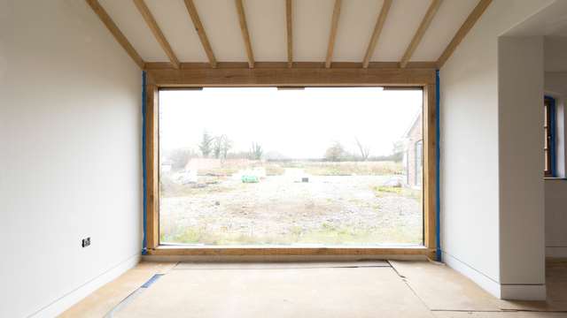 Large picture frame window in oak frame.