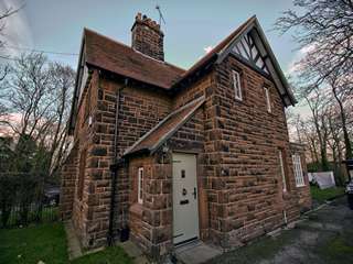 Full house view of Roodee cottage featuring timber effect windows and entrance door.