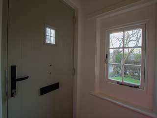 Internal shot of timber alternative UPVC flush casement window with traditional peg-stays and monkey tail handles in cast iron effect.