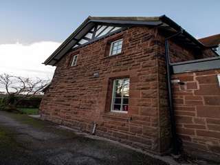 Side view of house showing installation of 3 timber alternative UPVC casement windows in this beautiful cottage, Frankby Wirral.