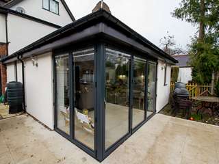 Close up of aluminium corner bifold doors closed showing corner post and cantilevered roof section.