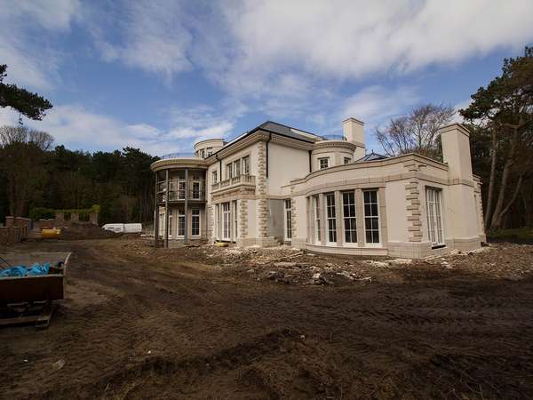 View of Firwood project with scaffolding removed, large installation of windows, doors and roof lanterns.