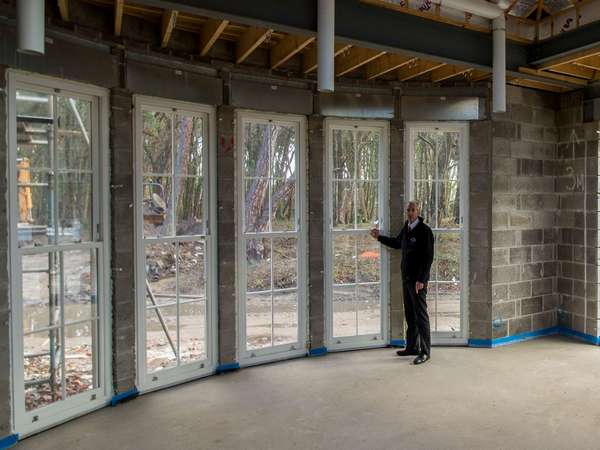 John standing next to these large UPVC sash windows to demonstrate the size of these stunning windows.