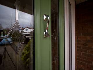 Close up of lead lights and chrome door knocker on the stunning entrance door.