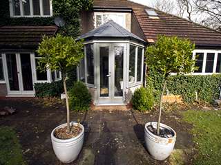 Old tired and rotten timber conservatory with polycarbonate roof replaced with insulated roof and Rationel alu-clad timber windows and doors. Overall U value has been vastly improved creating a space that is warm, comfortable and usable all year round.