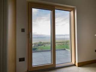 Internal view of Internorm lift and slide Alu-clad timber door, a great way to capture the view from the main bedroom and also gives access to the balcony.