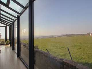 Making the most of the view from this bespoke aluminium gallery.
