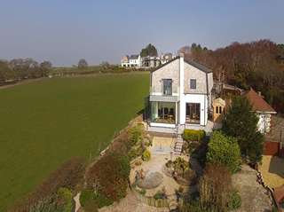 Straight on view of this full house installation with raised glass balcony area the perfect place to make the most of the countyside views and evening sunsets. All glazing is triple glazed throughout to maximise on energy efficiency.