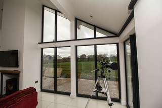 Internal corner view showing internal finishes. The steel structure has been clad internally with plasterboard with complimenting grey window boards.