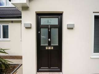 Black timber alternative entrance door with feature top light and chrome hardware.