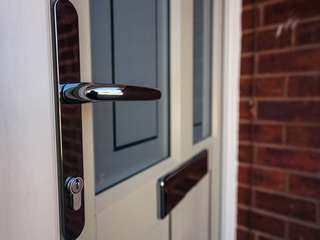 Door handle and letterbox in chrome to contrast with the door colour.