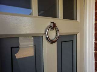Feature door knocker in chrome.
