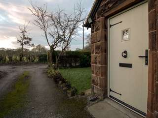 External view of green timber alternative entrance door from The English Door Company.