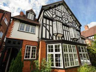 Full house installation showing bay windows and traditional casement storm windows. Windows featured a black frame and white casements all double glazed with a woodgrain affect to give the look and feel of timber.