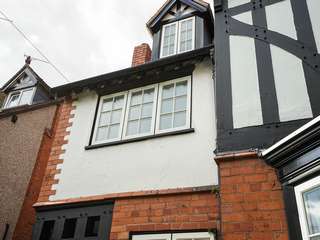 3 window casement with obscure glazing, black sill and black frame.