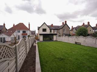 External view showing garden space and large aluminium sliding doors.