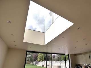 Insternal view of modern flat rooflight bringing in extra light to an otherwise dark space. Roof light is triple glazed with a U-value of 0.6 .