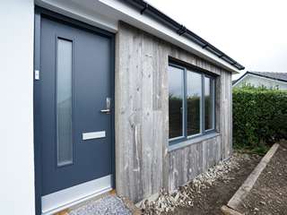 Rationel modern entrance door with matching grey colour to windows installed throughout this home.