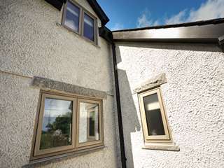 Close up detail of windows in rear corner of property.