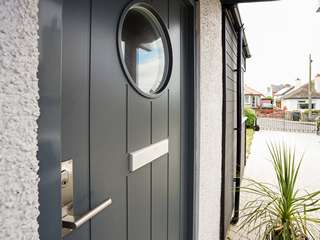 Close up of Entrance door detail, showing window, handle and letter box.