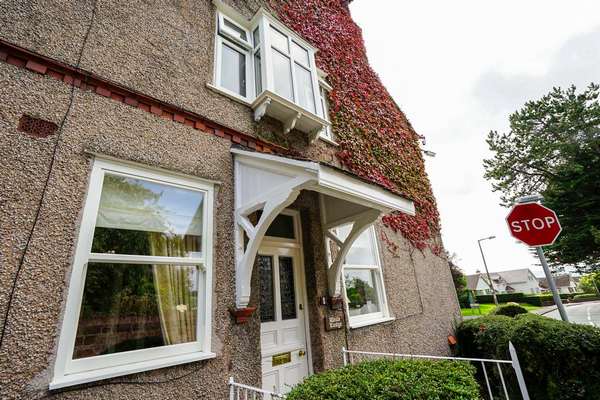 View of sliding sash windows and UPVC casement bay window with corner posts.