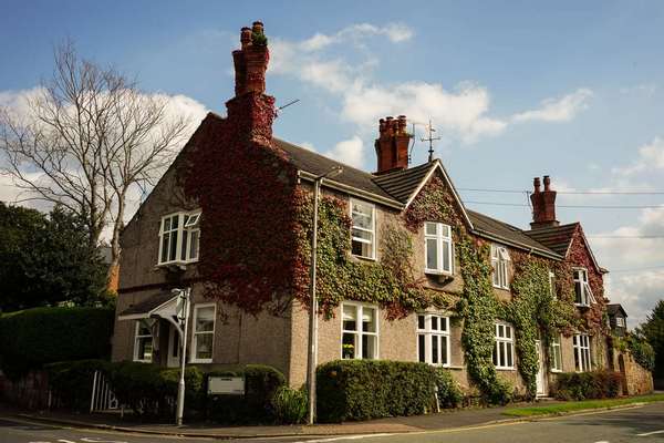 Full house picture showing a set of terraced cottages, end cottage has been updated with UPVC sash windows.