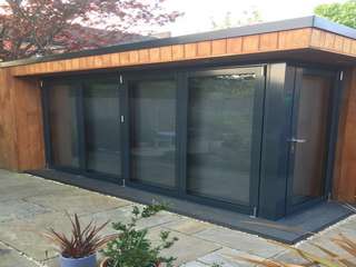 Installation of corner bifold doors in timber garden room.