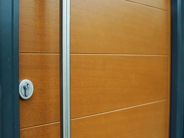 Close up of hardwood grain on timber entrance door.