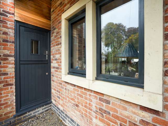 Rear stable door in RAL 7016 grey with matching windows.