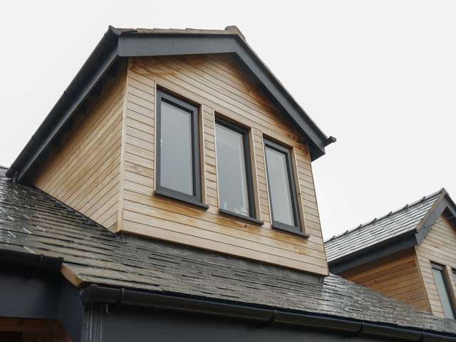 Close up of dormer window with triple aluminium casement windows.