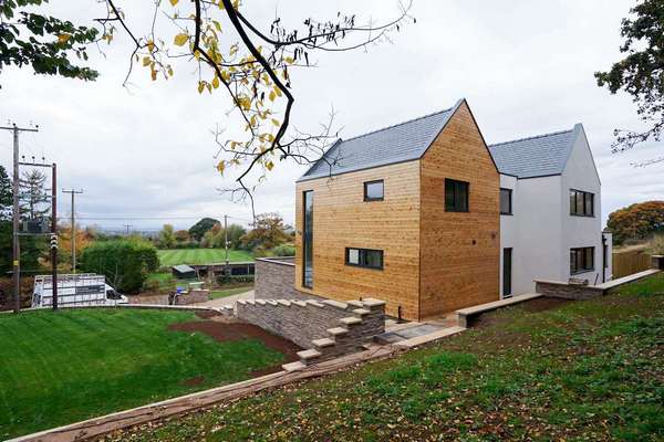 Alternative angle of the rear highlighting the vast views from this stunning new build development. The grey window work well against both the timber cladding and k-rend, and tieing in perfectly with the grey roof.
