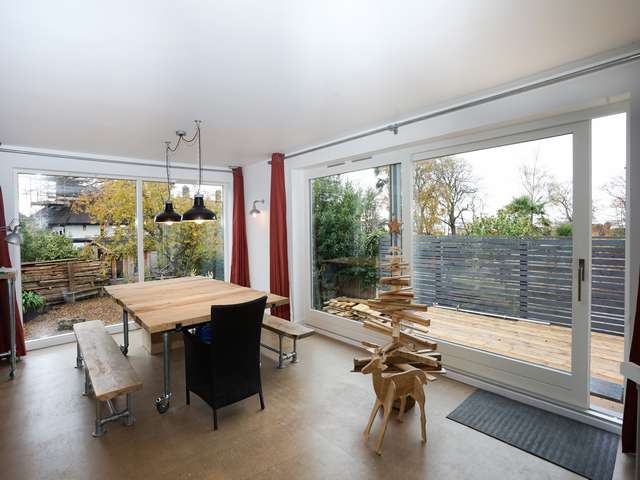 Internal dining space showing the soft internal finish of the wooden Rationel windows.