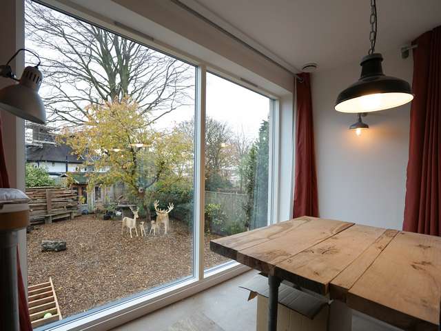 Large window bringing in lots of light into the newly created dining space and giving great views of the garden.
