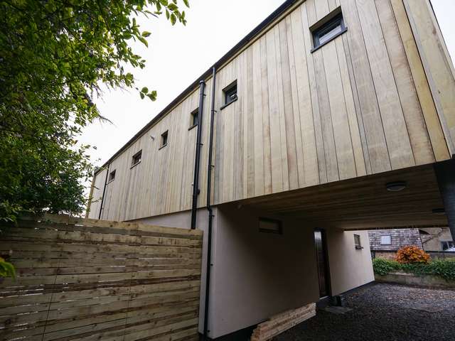 Rear view of the property with various Rationel utility windows to bring lights into the various room on the upper floor of the building.