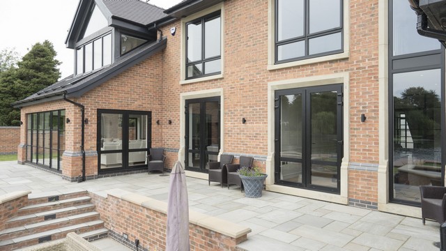 Another view of the back showing several sets of aluminium french doors with slim profiles.