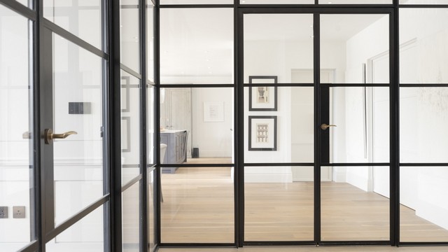 Close up of a dual Internal Crittall screen creating an L shape glass wall adding separation to this open plan home.