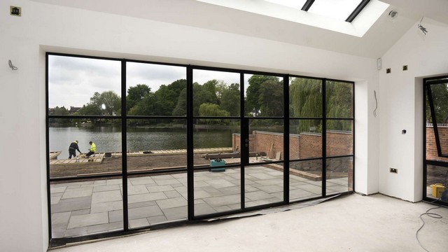Internal view of large Crittall screen in black with opening doors and sidelights.