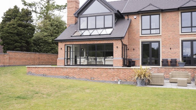 External view of the large Crittall door, rooflight and upper windows.