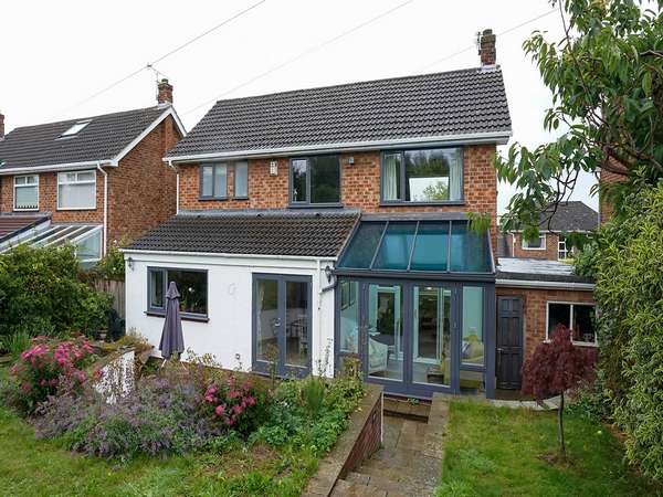 Wide shot of the rear of this property showing Ral 7019 double glazed Rationel timber windows, french doors and garden room.