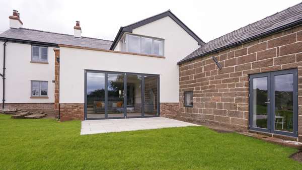 Close up of the Centor bifold in Ral7016 with matching Rationel alu-clad french doors and stainless steel hardware.