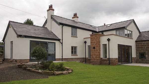 Main shot of the rear of the house showing the dual Centor bifolding doors, various Rationel windows with feature glazing bar and stunning corner window to the second floor.