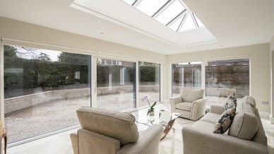 Large aluclad window and Internorm sliding door creating a garden room style to this space, complete with a large roof lantern. 