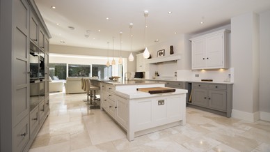 Another angle of the kitchen space with large glazing panels at one end.