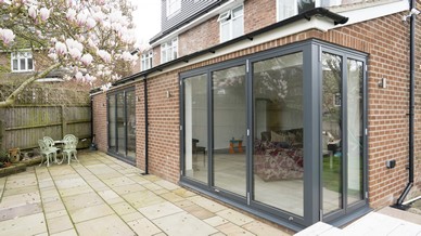 Overview of the dual bifolding door installation showing the ground floor extension externally.